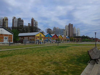 Built structure on grassy field against cloudy sky