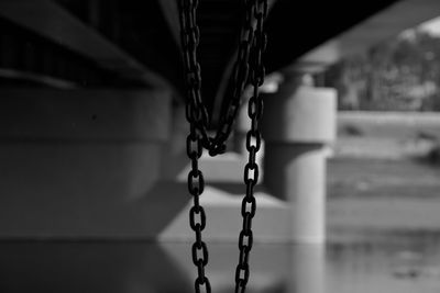Close-up of chain hanging on metal structure