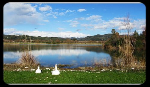 Scenic view of lake against cloudy sky