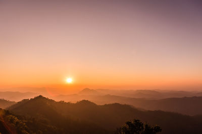 Scenic view of silhouette mountains against sky at sunset