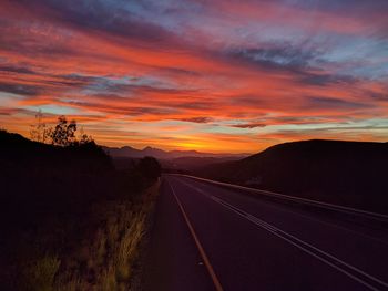 Road amidst landscape against sky during sunset