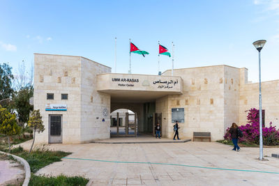 People in front of building against sky