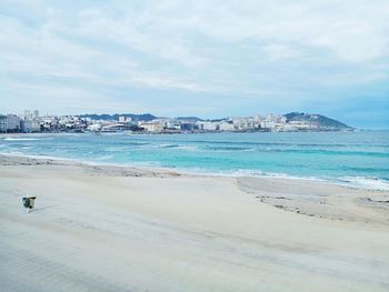 Scenic view of beach against sky in city