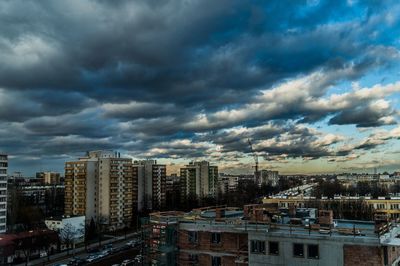 View of cityscape against dramatic sky