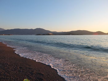 Scenic view of sea against clear sky during sunset