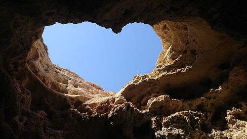 Low angle view of rock formation against clear sky