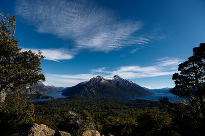 Scenic view of landscape and mountains against blue sky