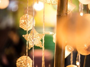 Close-up of illuminated lighting equipment hanging outdoors