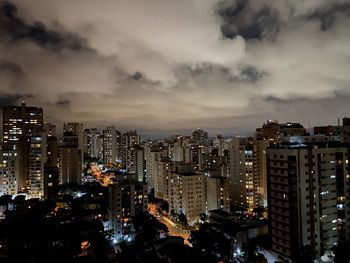 High angle view of illuminated buildings in city at dusk