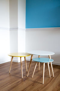 Close-up of table and chairs on hardwood floor at home