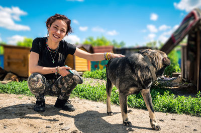 Dog at the shelter. animal shelter volunteer takes care of dogs. lonely dogs in cage with volunteer.