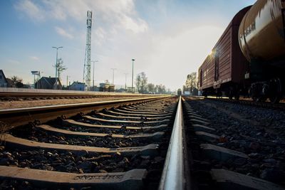 Freight train on railroad track against sky