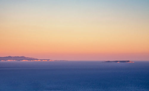 Scenic view of sea against romantic sky at sunset