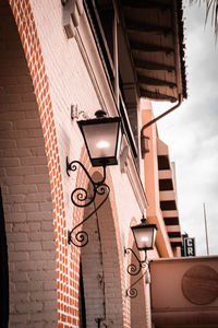 Low angle view of street light against building
