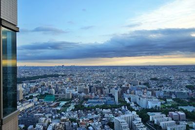 High angle view of city buildings against sky during sunset