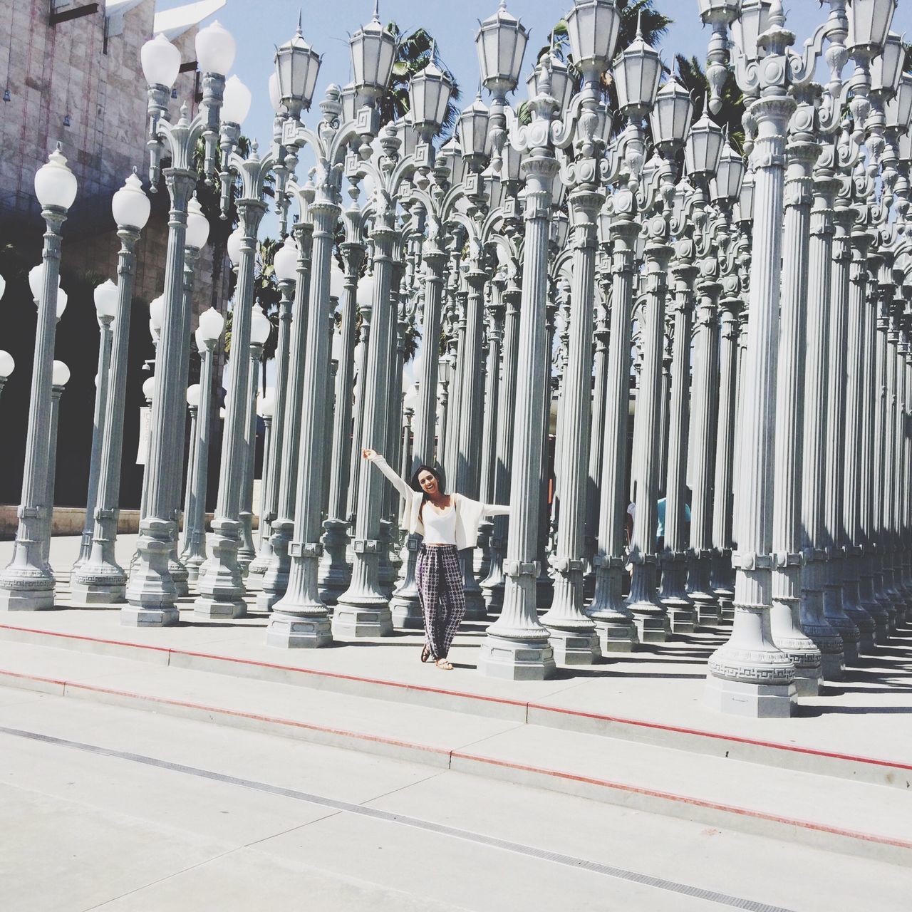 in a row, men, railing, transportation, hanging, large group of objects, lifestyles, metal, full length, day, person, walking, leisure activity, outdoors, abundance, side by side, fence, bicycle, repetition