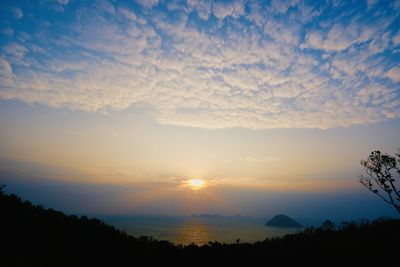 Scenic view of dramatic sky over silhouette landscape