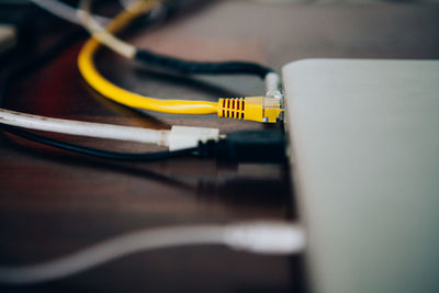 Close-up of computer cables connected to device on table