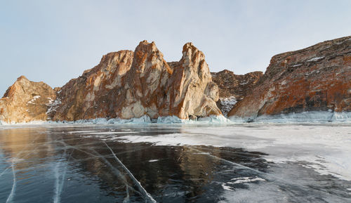 Panoramic view of sea and mountains against sky