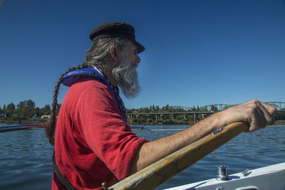 Midsection of man against blue sky