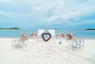 Entertainment tent at beach against cloudy sky