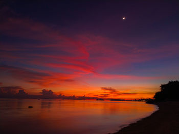 Scenic view of lake against romantic sky at sunset
