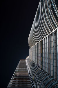 Directly below shot of petronas towers against clear sky