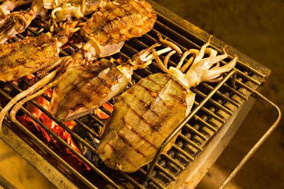 High angle view of meat on barbecue grill