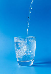 Close-up of water splashing against blue sky