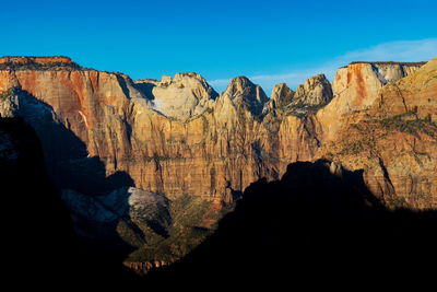 Scenic view of mountain against blue sky