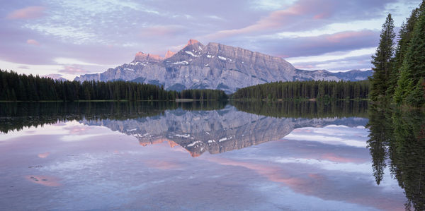 Scenic view of lake by trees against sky