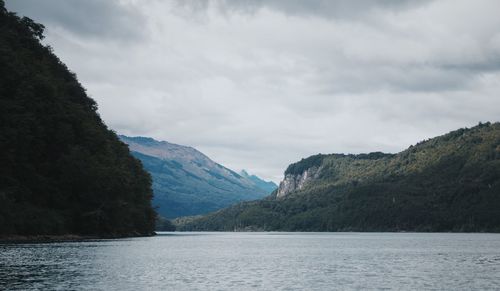 Scenic view of lake and mountains against sky