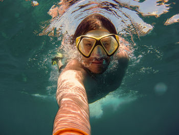 Portrait of woman swimming in sea