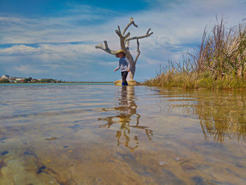 Portrait of boy standing lake