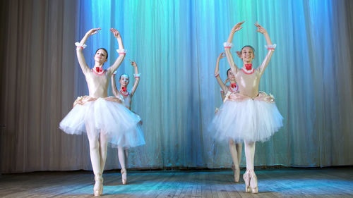 Ballet rehearsal, on the stage of the old theater hall. young ballerinas in elegant dresses