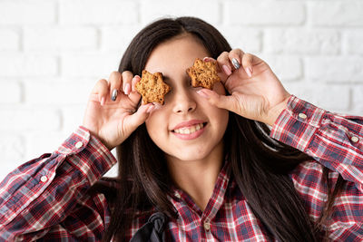 Portrait of smiling young woman holding ice cream