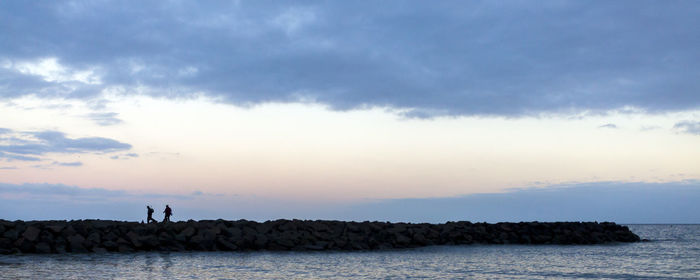 Scenic view of sea against cloudy sky