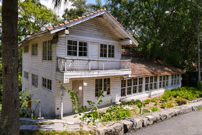 House amidst trees and buildings in city