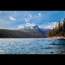 Scenic view of lake against cloudy sky