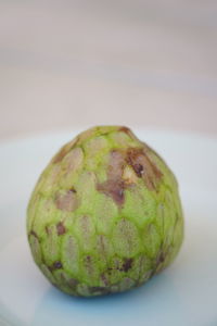 Close-up of fruit on table against white background