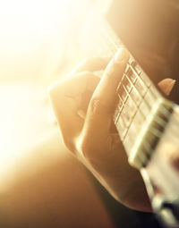 Cropped image of woman playing guitar