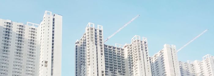 Low angle view of buildings against clear blue sky