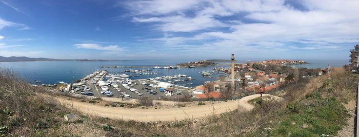 High angle view of townscape by sea against sky