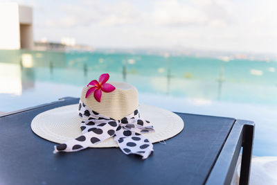 Close-up of heart shape on table against sea