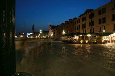 Illuminated city street at night
