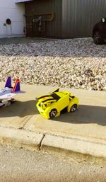 Yellow toy car on beach