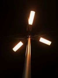Low angle view of illuminated electric light against sky