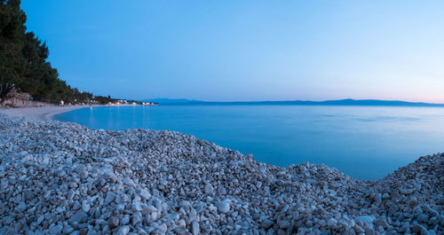 Scenic view of sea against clear blue sky