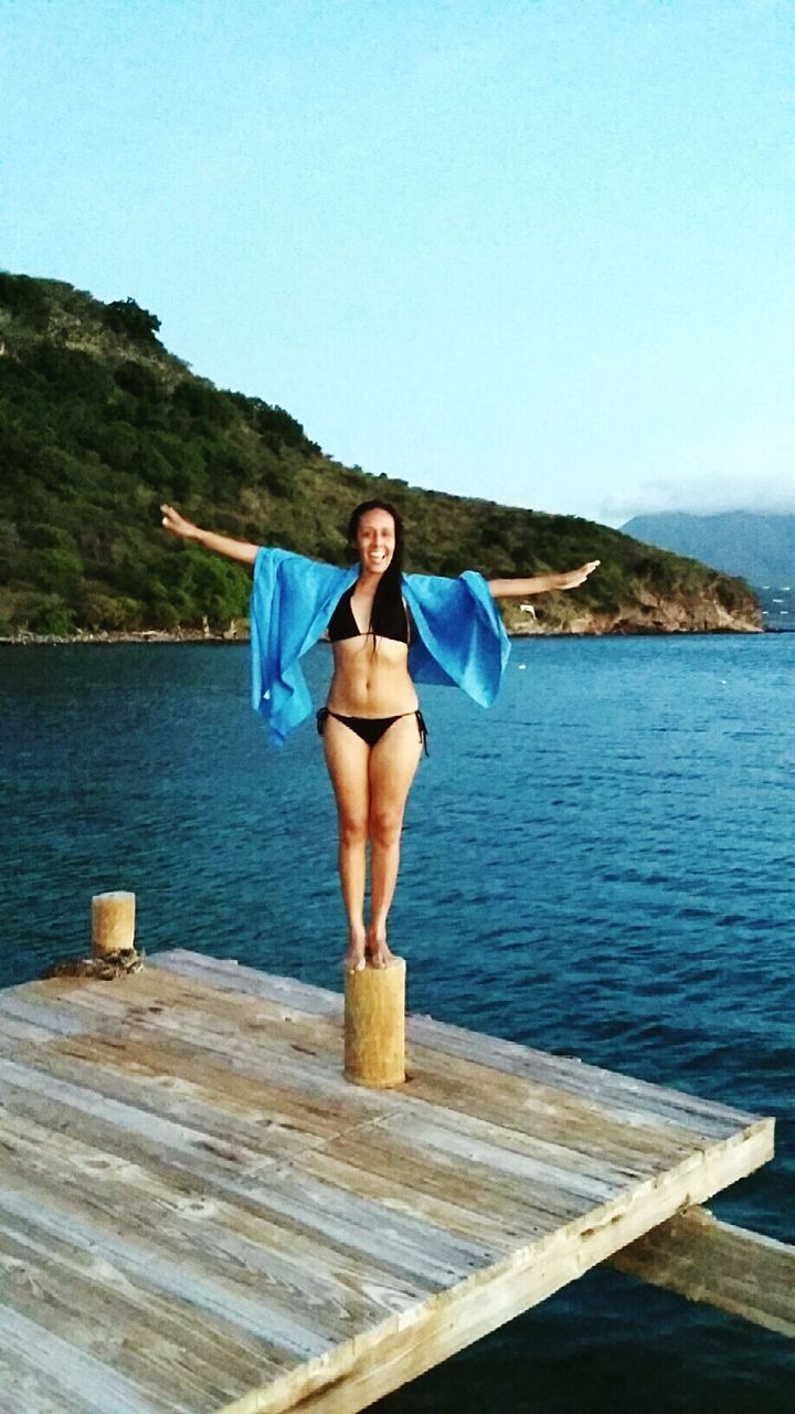 HIGH ANGLE VIEW OF YOUNG WOMAN IN SEA