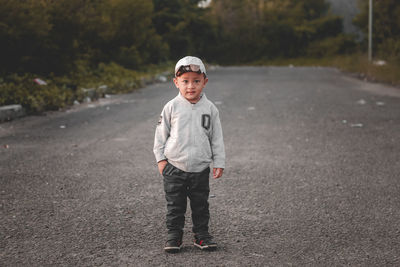 Portrait of young man standing on road